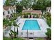 Overhead shot of a refreshing community pool surrounded by a secure fence and lush greenery at 2302 Maki Rd # 69, Plant City, FL 33563