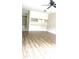 Bright open living area with hardwood floors, a ceiling fan, and access to shelving and the kitchen at 2302 Maki Rd # 69, Plant City, FL 33563