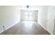 Bright living room featuring sleek wood floors, a ceiling fan, and a large window letting in natural light at 2302 Maki Rd # 69, Plant City, FL 33563