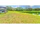 Expansive backyard with lush green grass and a serene lake view, perfect for outdoor relaxation and activities at 2424 Caraway Dr, Venice, FL 34292