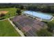 Aerial view of community sports courts including hockey, tennis, and a basketball court with multiple hoops at 2424 Caraway Dr, Venice, FL 34292