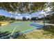 Outdoor basketball court with blue and green playing surface, ready for a game at 2424 Caraway Dr, Venice, FL 34292