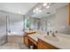 Bathroom featuring a soaking tub, separate glass shower, and double vanity with storage at 2424 Caraway Dr, Venice, FL 34292