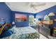 Bedroom featuring bright blue walls, a seashell patterned bedspread, and a window with natural light at 2424 Caraway Dr, Venice, FL 34292