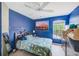 Bedroom featuring bright blue walls, a seashell patterned bedspread, and a window with natural light at 2424 Caraway Dr, Venice, FL 34292
