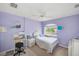 Bright bedroom with a bed, desk, chair, and white wicker furniture in a cozy, stylish setup at 2424 Caraway Dr, Venice, FL 34292