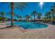 Expansive community pool featuring a brick deck, palm trees, and plenty of space for residents to enjoy at 2424 Caraway Dr, Venice, FL 34292