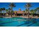 Inviting community pool with clear blue water, surrounded by palm trees and ample seating for residents at 2424 Caraway Dr, Venice, FL 34292