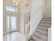 Inviting foyer with white tile flooring, staircase, and chandelier at 2424 Caraway Dr, Venice, FL 34292