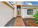 Inviting front entrance featuring a brick path, manicured garden, and neutral facade, creating great curb appeal at 2424 Caraway Dr, Venice, FL 34292