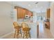 Kitchen with wooden cabinetry, breakfast bar, and modern appliances at 2424 Caraway Dr, Venice, FL 34292