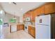 Cozy kitchen with oak cabinets, modern appliances, and tile floor at 2424 Caraway Dr, Venice, FL 34292
