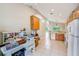 Open floor plan showcasing the kitchen, office area, tile floors, and lots of natural light at 2424 Caraway Dr, Venice, FL 34292