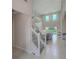 Bright and airy living room with staircase and views of the pool at 2424 Caraway Dr, Venice, FL 34292