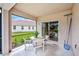 Cozy screened lanai with patio furniture, perfect for enjoying outdoor living and overlooking the landscaped backyard at 2424 Caraway Dr, Venice, FL 34292