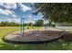 Community playground with swings and sports field under a sunny sky at 2424 Caraway Dr, Venice, FL 34292