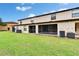 Spacious backyard with a lush lawn and screened-in lanai, perfect for outdoor enjoyment at 2435 Edgewater Falls Dr, Brandon, FL 33511