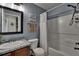 Guest bathroom features updated vanity, framed mirror, and shower-tub combination at 2435 Edgewater Falls Dr, Brandon, FL 33511