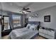 Bedroom boasts a ceiling fan, window with curtains, and mirrored wall at 2435 Edgewater Falls Dr, Brandon, FL 33511