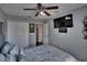 Bedroom boasts a ceiling fan, television, and ensuite access at 2435 Edgewater Falls Dr, Brandon, FL 33511