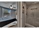 Bedroom leads to ensuite bathroom featuring an updated tiled walk-in shower with glass door at 2435 Edgewater Falls Dr, Brandon, FL 33511