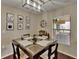 Dining room with modern lighting, glass table, and window view at 2435 Edgewater Falls Dr, Brandon, FL 33511