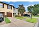 Well-maintained townhome featuring a single-car garage, landscaped lawn, and paved driveway at 2435 Edgewater Falls Dr, Brandon, FL 33511