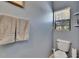 Cozy half-bathroom featuring fresh towels, a toilet, and bright natural light at 2435 Edgewater Falls Dr, Brandon, FL 33511
