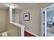 Upstairs hallway features wood floors, wall art, and access to bedrooms at 2435 Edgewater Falls Dr, Brandon, FL 33511