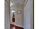 Hallway with dark wood floors, featuring linen closets and bathroom with granite vanity at 2435 Edgewater Falls Dr, Brandon, FL 33511
