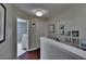 Upstairs hallway features wood floors, wall art, and access to bedrooms at 2435 Edgewater Falls Dr, Brandon, FL 33511