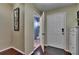 Bright hallway with wood floors, leading to a bathroom, featuring stylish decor at 2435 Edgewater Falls Dr, Brandon, FL 33511