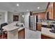 Bright kitchen with stainless steel refrigerator, breakfast bar, and tile flooring at 2435 Edgewater Falls Dr, Brandon, FL 33511