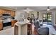 Open-concept room featuring a modern kitchen with stainless appliances and cozy living area with sliding glass doors at 2435 Edgewater Falls Dr, Brandon, FL 33511