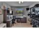 Well-lit home office with a sleek built-in desk, shelving, and outdoor views at 2435 Edgewater Falls Dr, Brandon, FL 33511