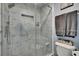 Bathroom featuring tiled walk-in shower, built-in niche, showerhead, and glass door at 2435 Edgewater Falls Dr, Brandon, FL 33511
