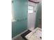 Cozy bathroom with a tile shower, granite countertop, and a window allowing natural light at 2444 35Th N St, St Petersburg, FL 33713