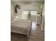 Bedroom with wood-look floors, a dresser, and a window with natural light at 2444 35Th N St, St Petersburg, FL 33713
