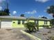 Charming one-story home with a lush green lawn, features a garage, and is bathed in bright sunlight at 2444 35Th N St, St Petersburg, FL 33713