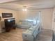 Bright and cozy living room featuring wood floors, a ceiling fan, and a comfortable seating arrangement at 2444 35Th N St, St Petersburg, FL 33713