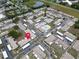 Aerial view of a condo community with shared pool, parking and lake in a well-maintained location at 24862 Us Highway 19 N # 1105, Clearwater, FL 33763