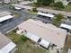 Aerial view of a low rise condo complex and parking, surrounded by lawn at 24862 Us Highway 19 N # 1105, Clearwater, FL 33763