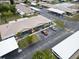 Aerial view of low rise condos with covered parking, lawns and a mature trees at 24862 Us Highway 19 N # 1105, Clearwater, FL 33763