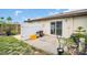 A small patio area in a backyard with a white privacy fence and partial greenery at 24862 Us Highway 19 N # 1105, Clearwater, FL 33763