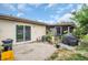 Patio with slider door, screened porch, greenery, and a black grill and yellow bin at 24862 Us Highway 19 N # 1105, Clearwater, FL 33763