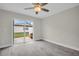 Bright bedroom features modern flooring, sliding glass doors to the patio, and neutral paint at 24862 Us Highway 19 N # 1105, Clearwater, FL 33763
