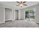 Bright bedroom features modern flooring, sliding glass doors to the patio, and an open closet at 24862 Us Highway 19 N # 1105, Clearwater, FL 33763