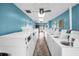 Well-lit laundry room with many white washing machines against blue walls at 24862 Us Highway 19 N # 1105, Clearwater, FL 33763