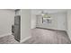 Inviting living room next to kitchen features modern flooring, neutral paint, stainless steel appliances, and lots of natural light at 24862 Us Highway 19 N # 1105, Clearwater, FL 33763