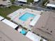 Aerial view of community pool with lounge chairs, umbrellas, and a white fence at 24862 Us Highway 19 N # 1105, Clearwater, FL 33763